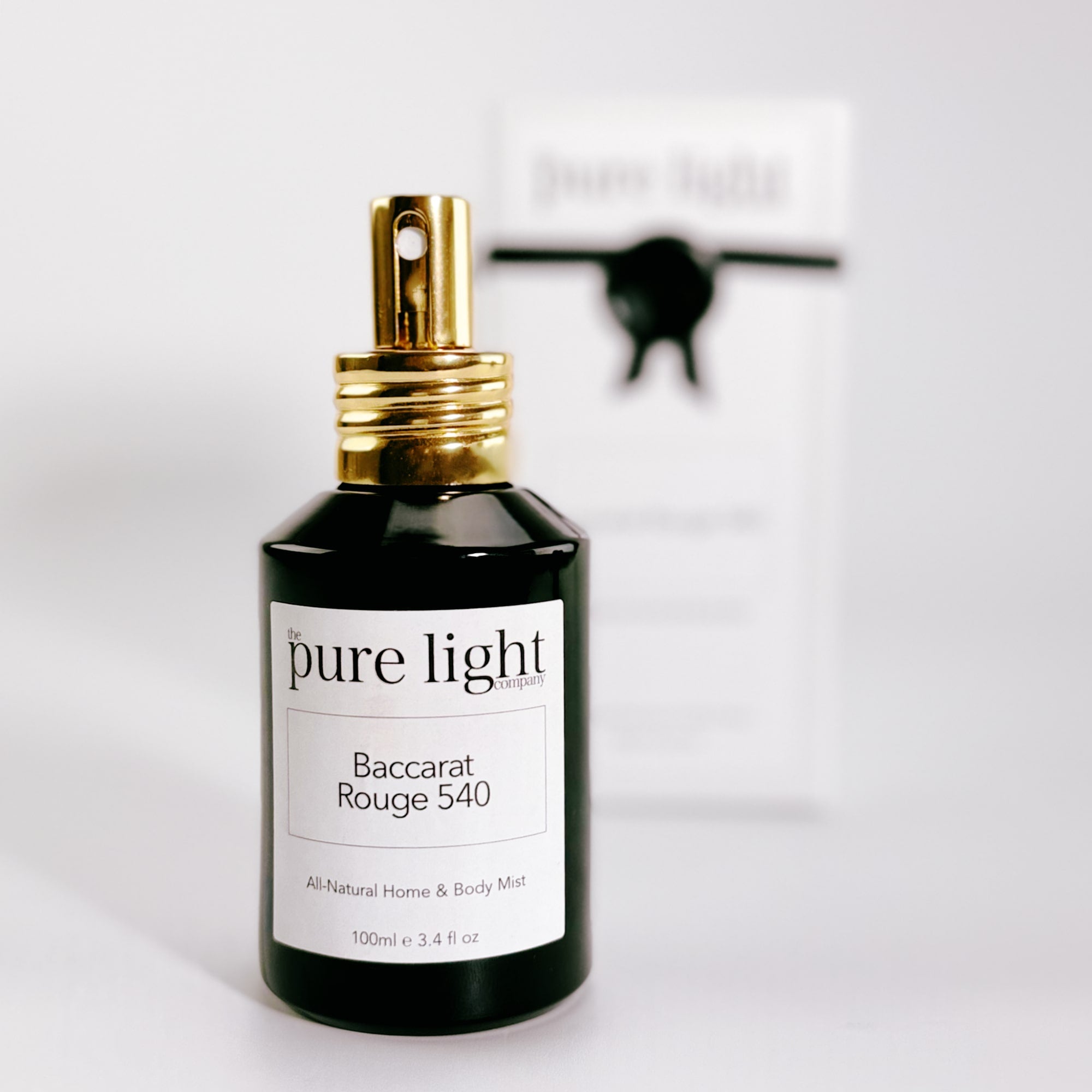 A black glossy bottle of Baccarat Rouge 540 All-Natural Spray Mist 100ml by The Pure Light Company