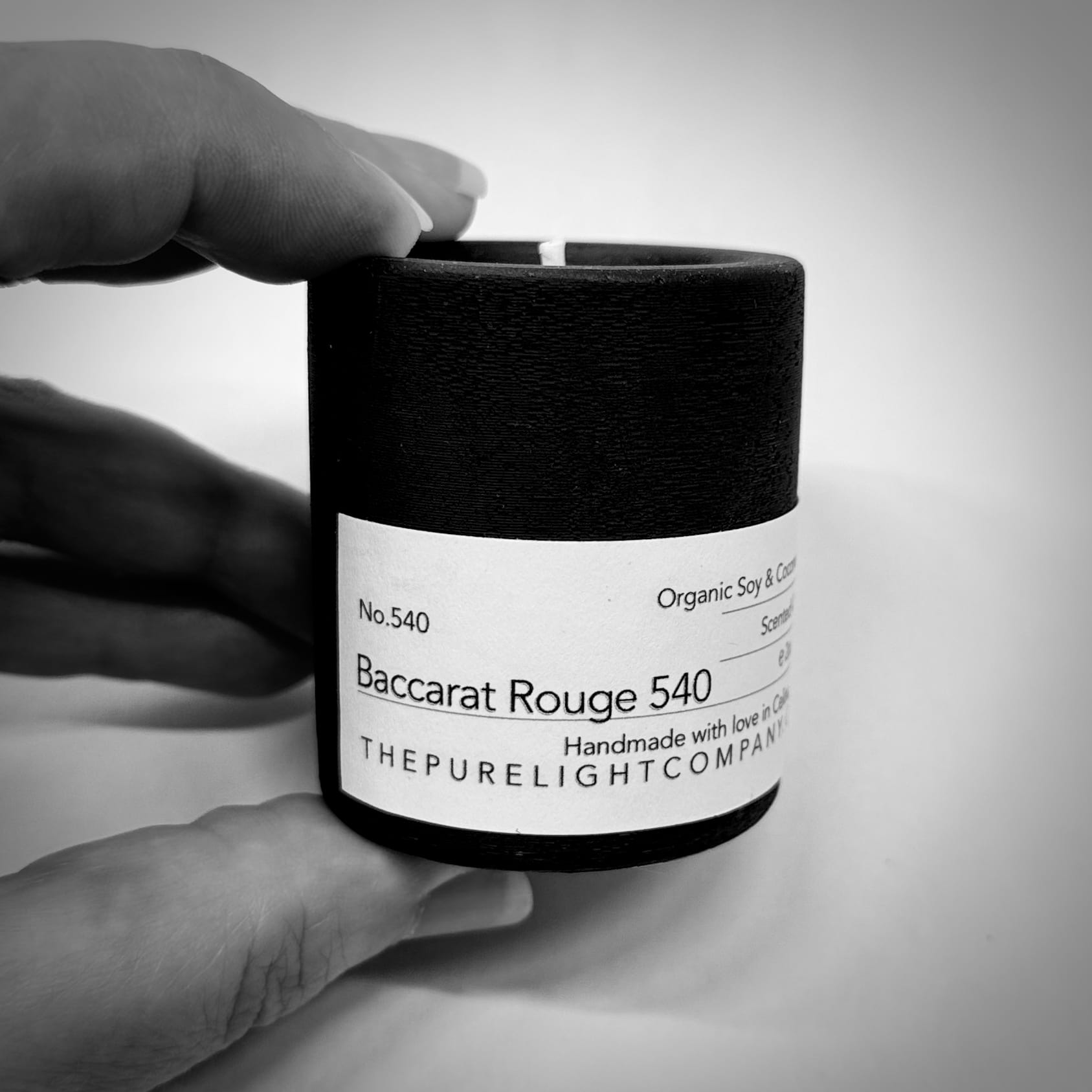Mini Baccarat Rouge 540 concrete candle lifestyle shot being held in a hand by The Pure Light Company.