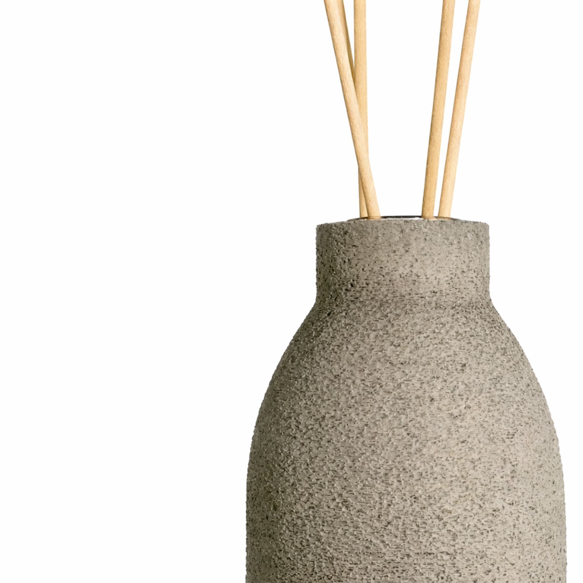 Concrete diffuser bottle in gray with wooden sticks on a white background
