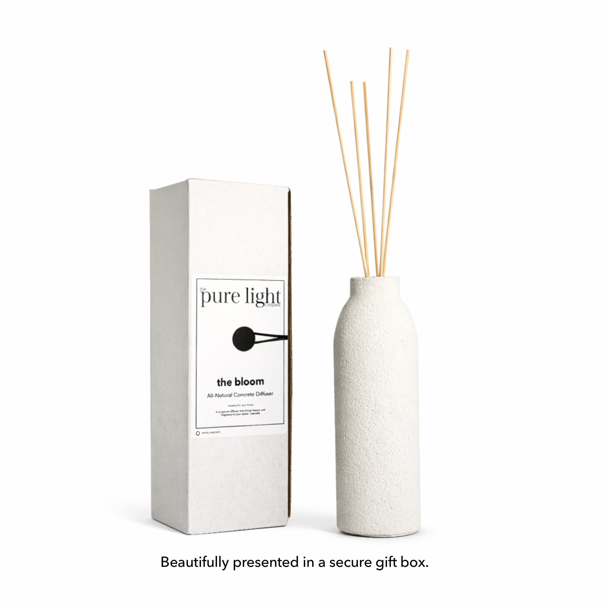 White large concrete diffuser bottle with natural reeds and packaging labeled The Pure Light Company on a white background