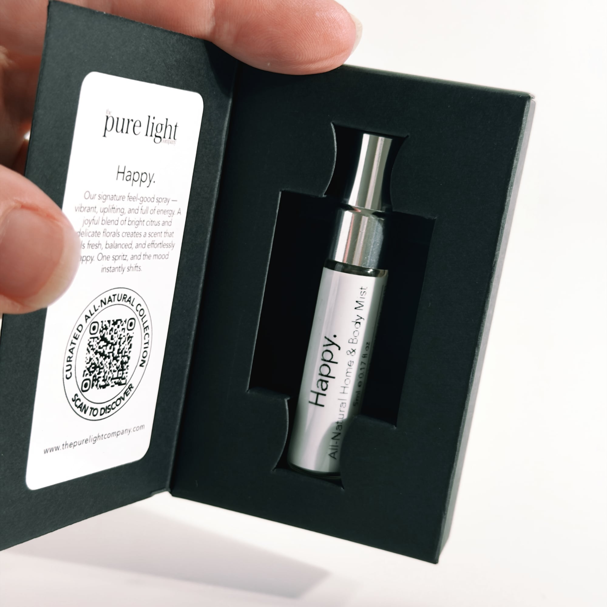 Silver 'Happy' All Natural Home and Body Mist in a black box by The Pure Light Company