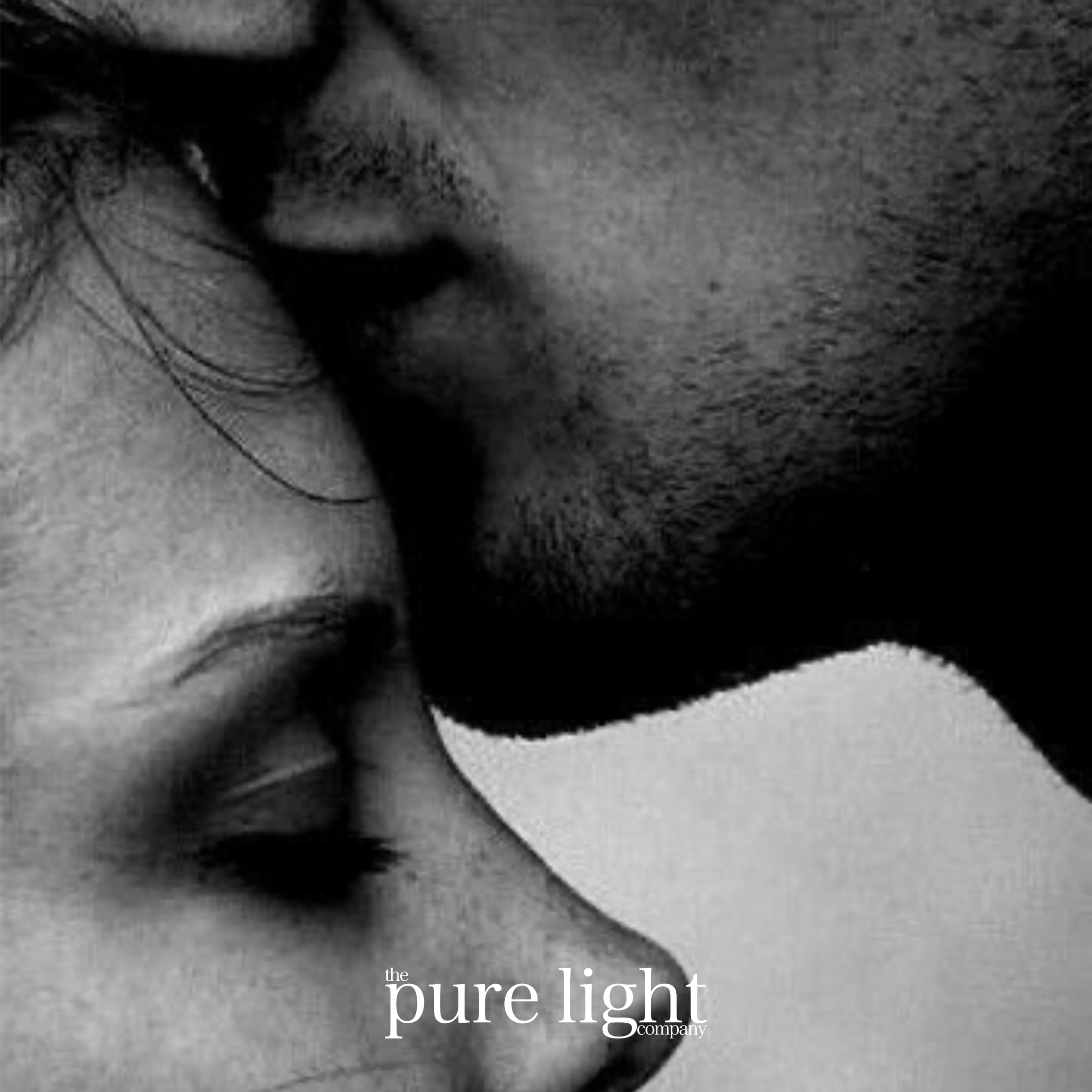 A tender image of a man kissing a woman's forehead with The Pure Light Company logo for the Love Story Collection of all-natural home fragrance