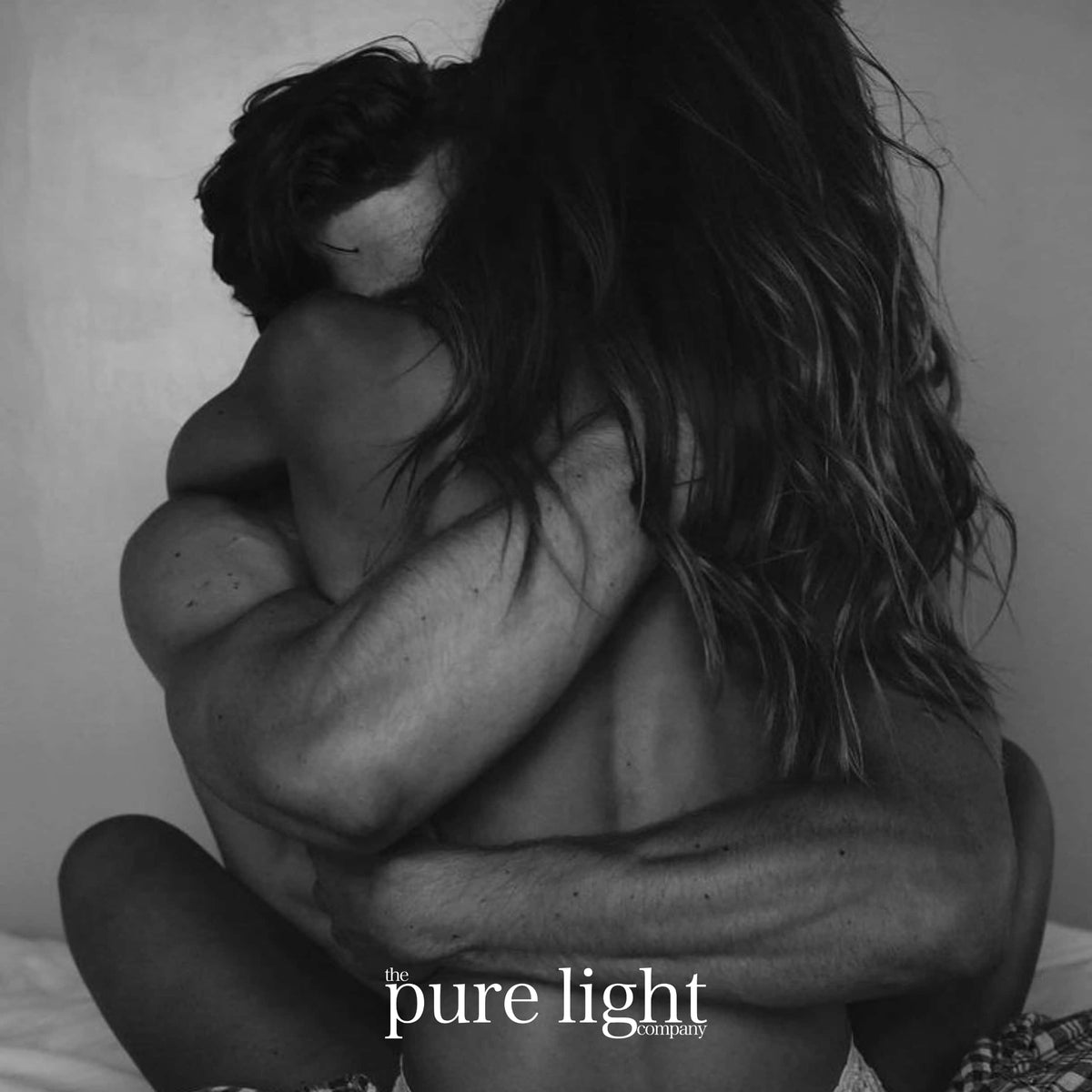 Santal 33 Collection Black and white photograph of a couple embracing from behind, with the text 'the pure light community' at the bottom.