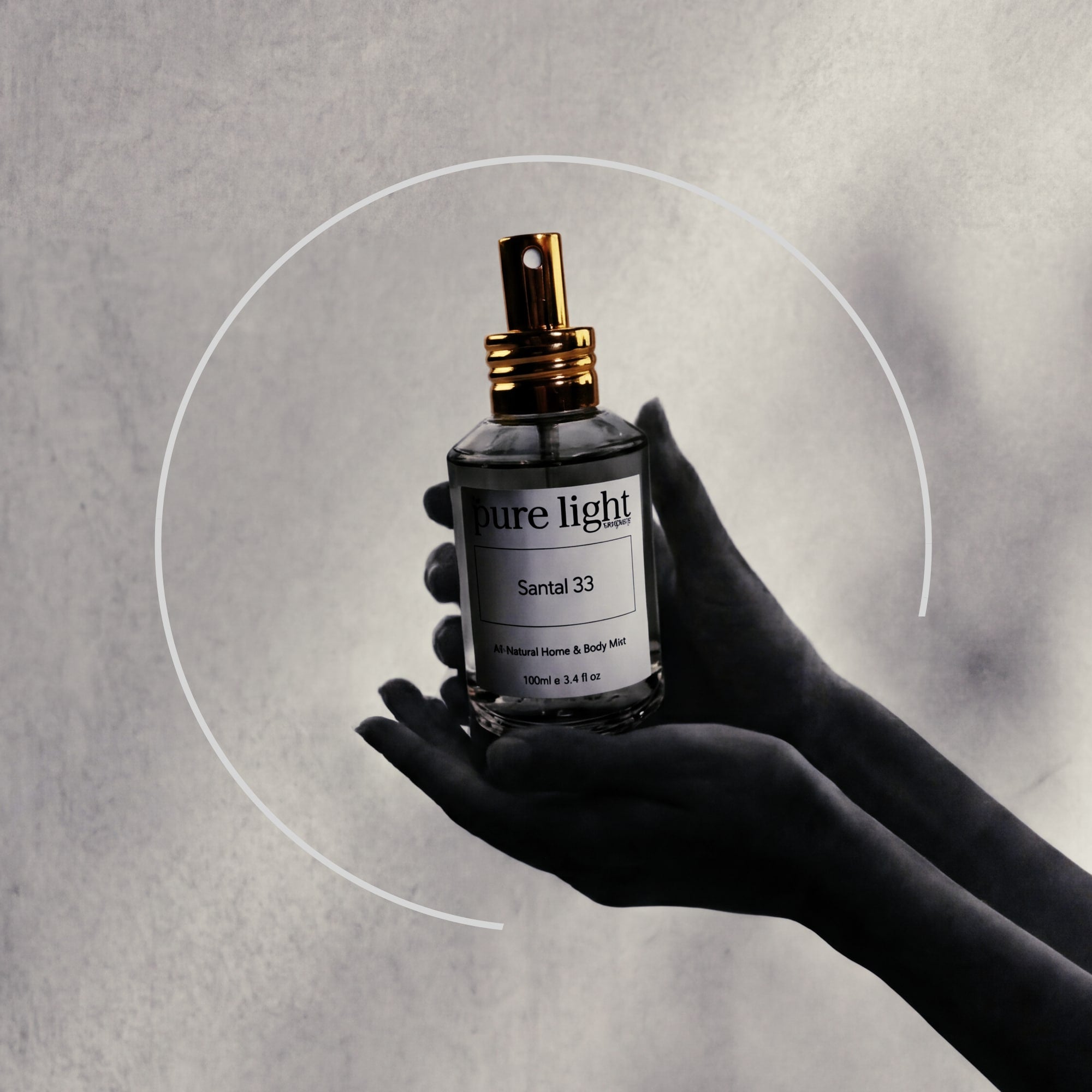 Hand holding a 'Pure Light Santal 33' perfume bottle against a gray background