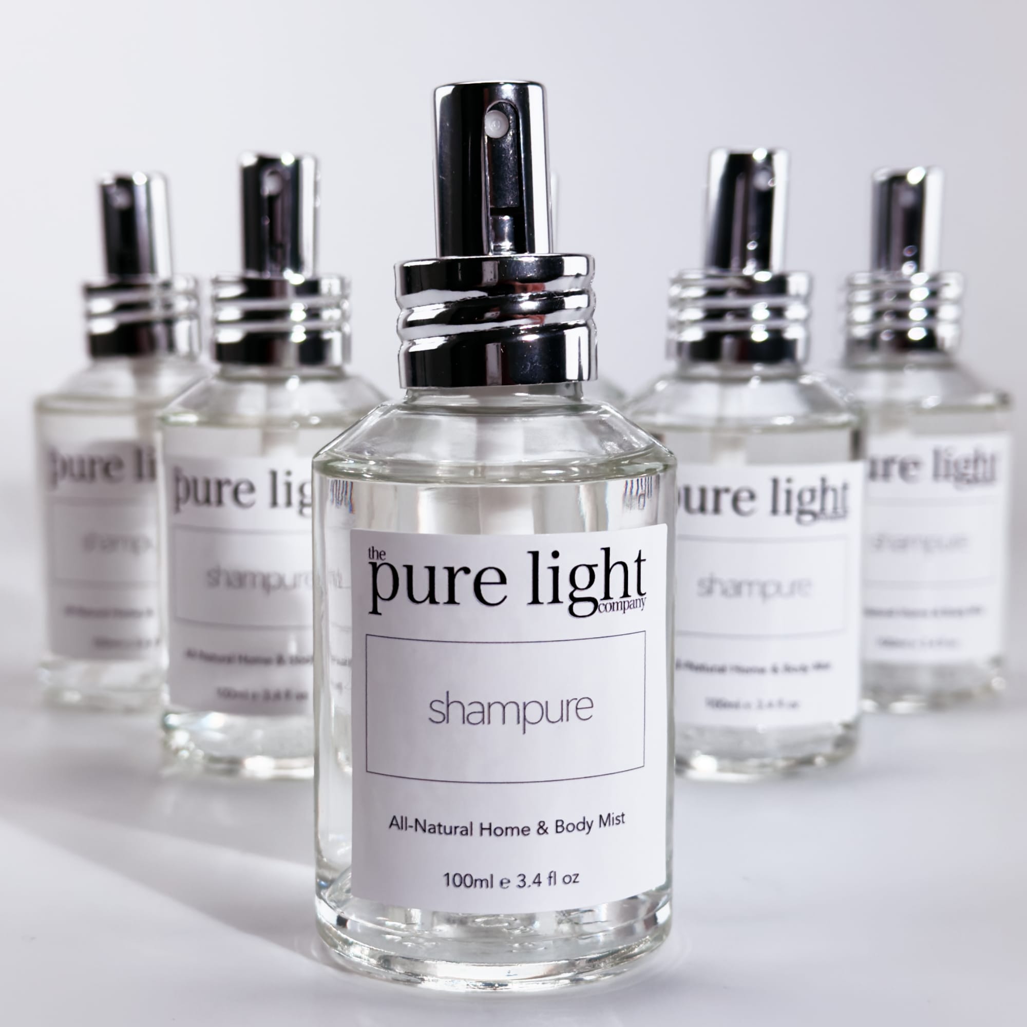 Bottles of clear glass All-Natural Fragrance Mists in Shampure 100ml spray by The Pure Light Company