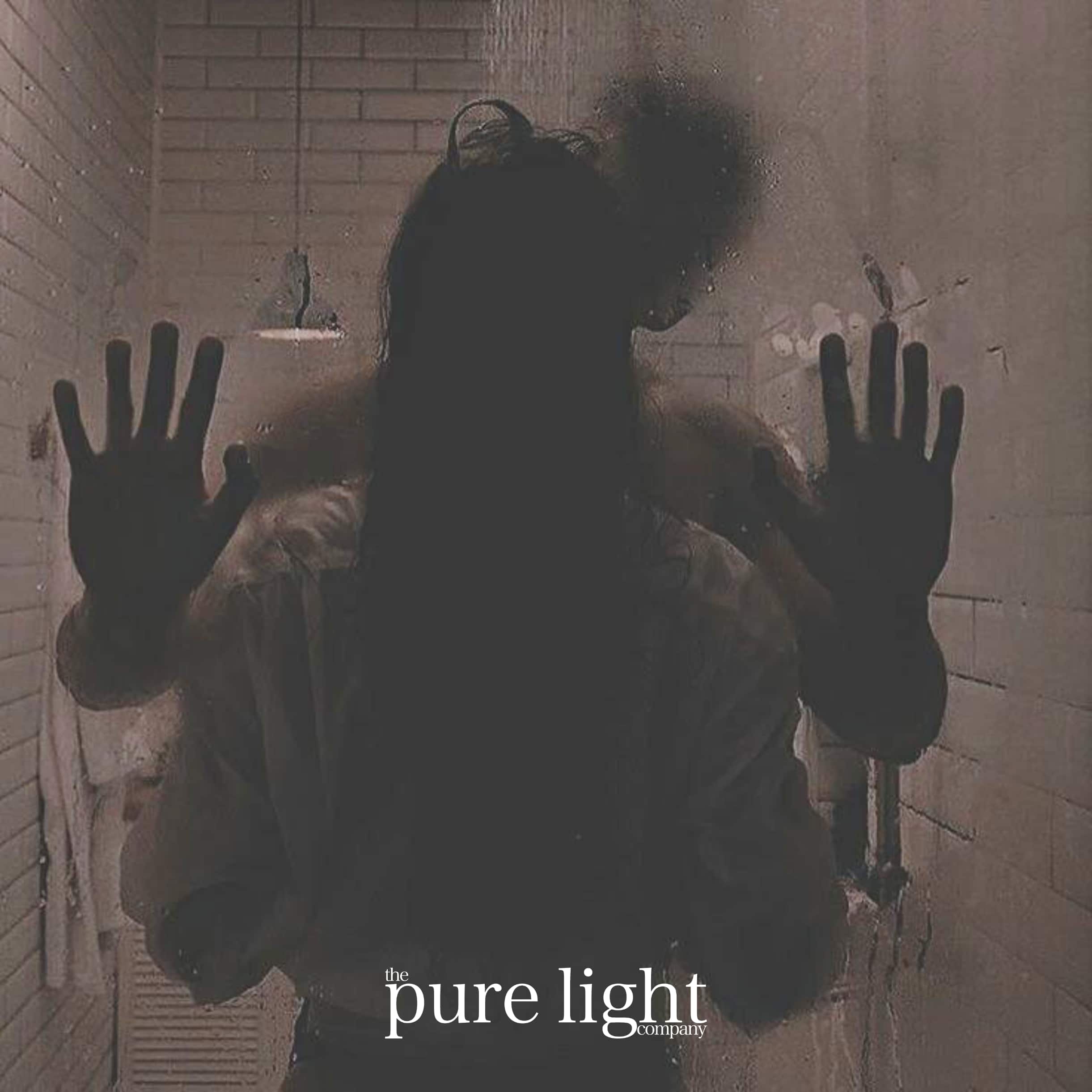 Person with hands pressed against a glass door in a dimly lit room, with 'the pure light company' text.