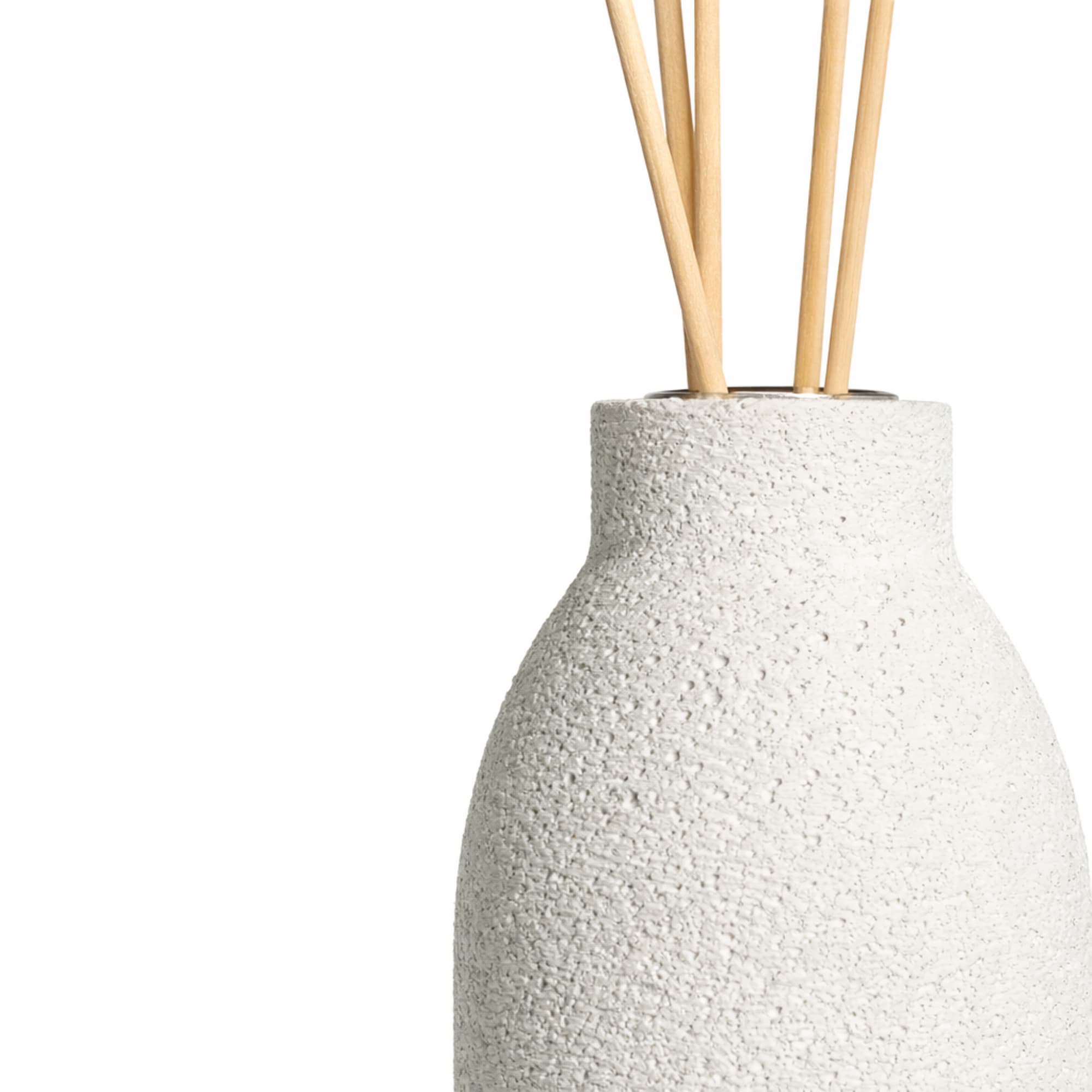 Textured white concrete diffuser with wooden sticks on a white background