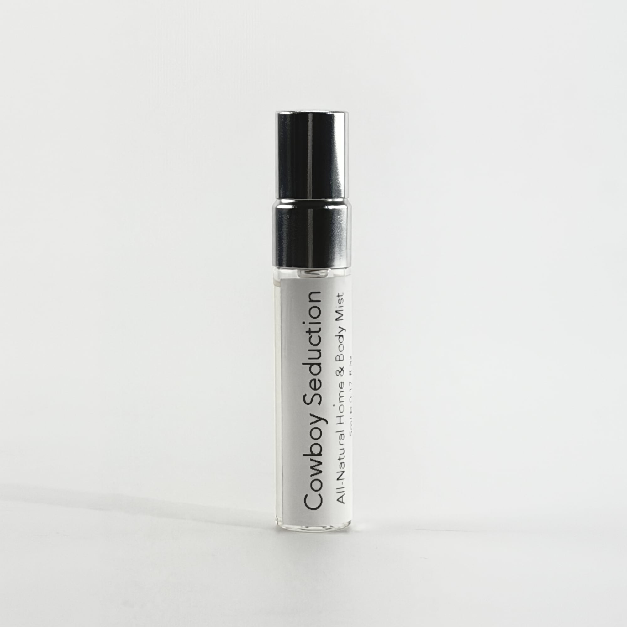 Cowboy Seduction all-natural hair & body mist 5ml bottle on a white background by The Pure Light Company