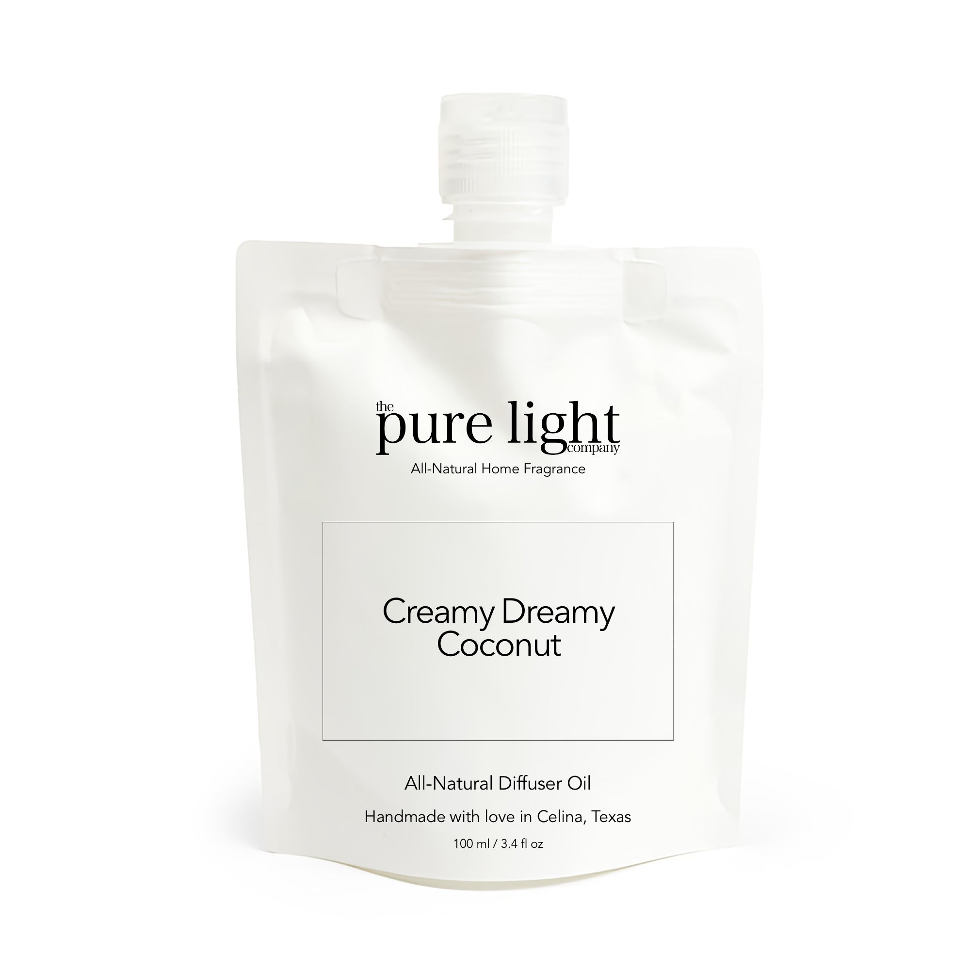 White packaging of The Pure Light Company diffuser oil with 'Creamy Dreamy Coconut' text on a white background