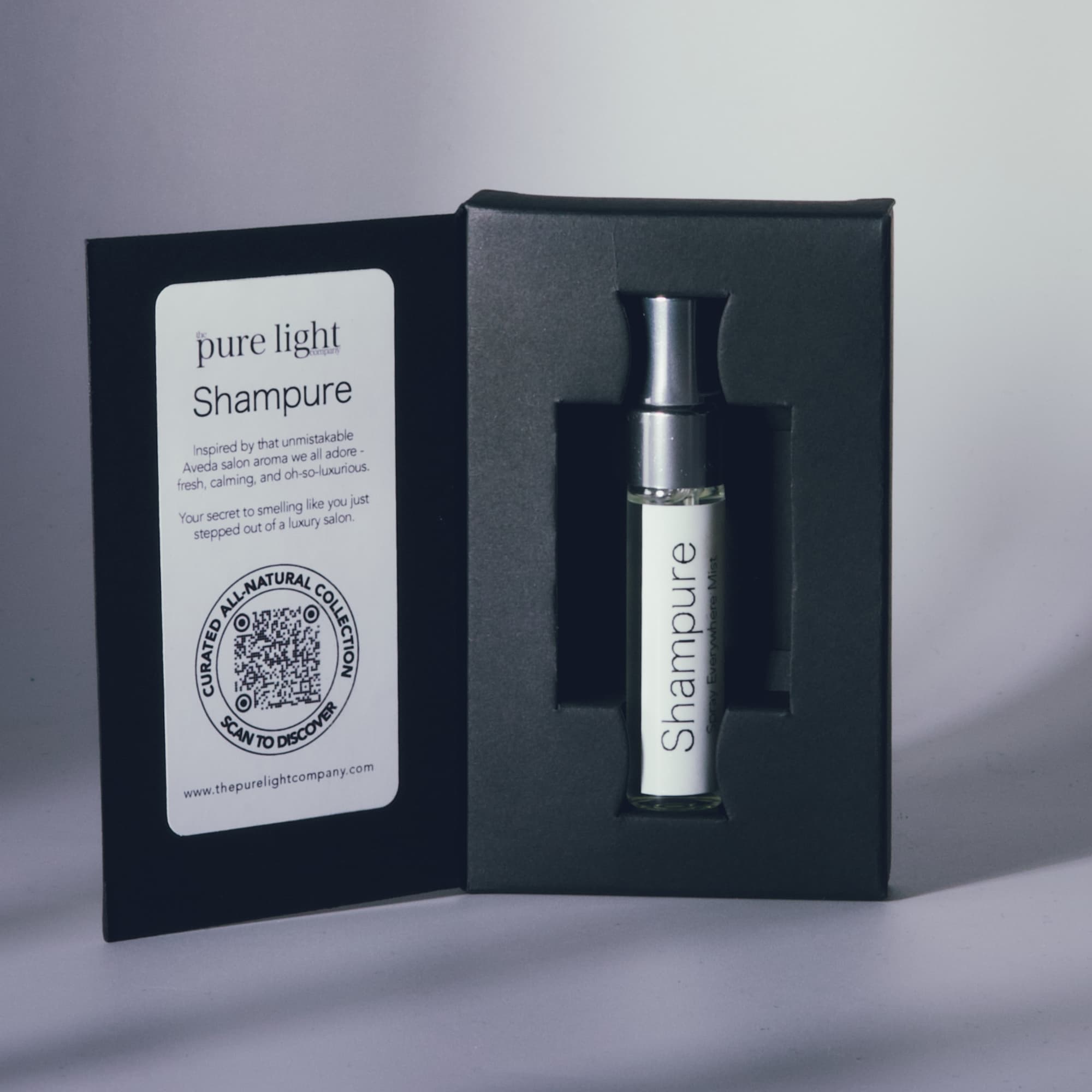 Shampure Aveda Dupe All-Natural Home and Body Mist bottle in a black box with a label on a gray background by The Pure Light Company.